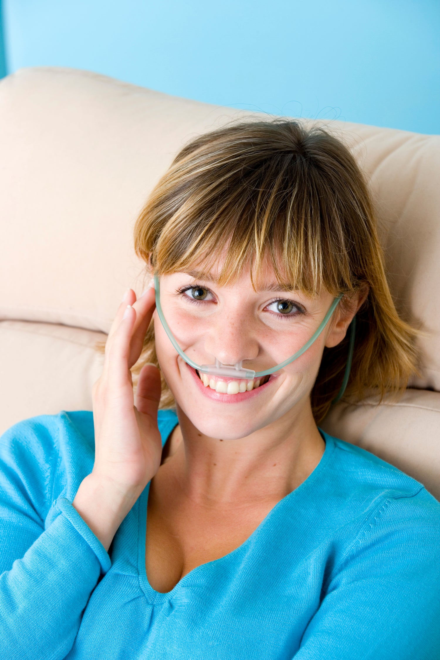 Female wearing a nasal cannula and smiling